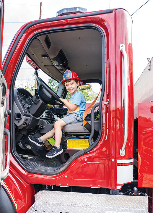 Barrett Gregory, 3, of Pacific explores a firetruck at the BackStoppers event.
